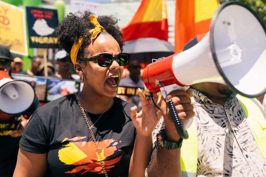 Fanna Tedla speaks into a megaphone at a Tigray rally.
