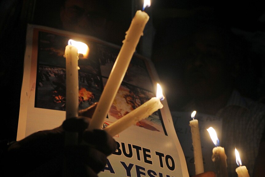 Exiled Tibetans hold a vigil