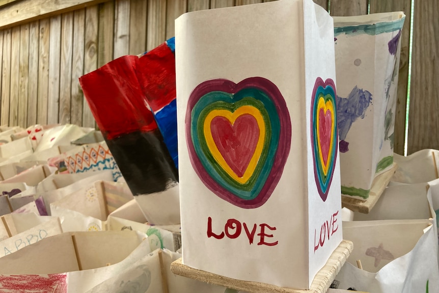 A rectangle paper with a colourful loveheart and the word 'love'