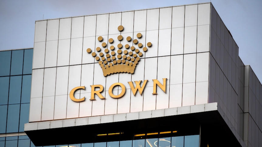 A close-up shot of a logo of Crown Resorts on the top of a high-rise building in Perth.