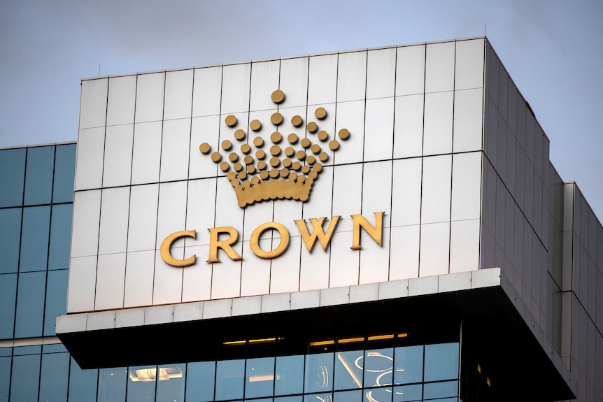 A close-up shot of a logo of Crown Resorts on the top of a high-rise building in Perth.