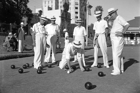 A black-and-white image of men playing bowls.
