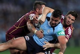 Maroons players tackle NSW's Andrew Fifita