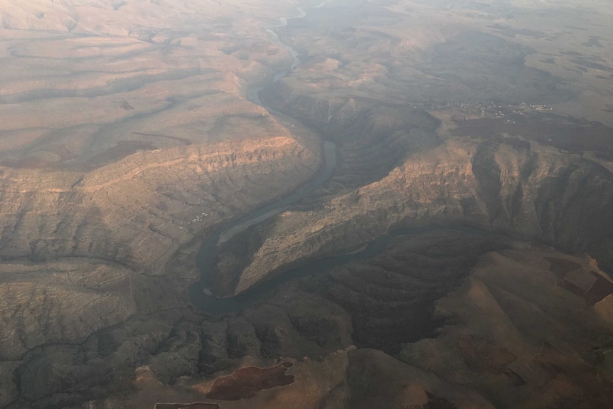 Aerial of rugged mountains of southern Turkey with river slicing through valley.