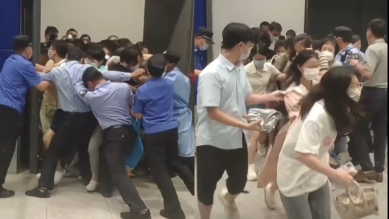 Customers rush out of an Ikea store in Shanghai and authorities try and stop them.