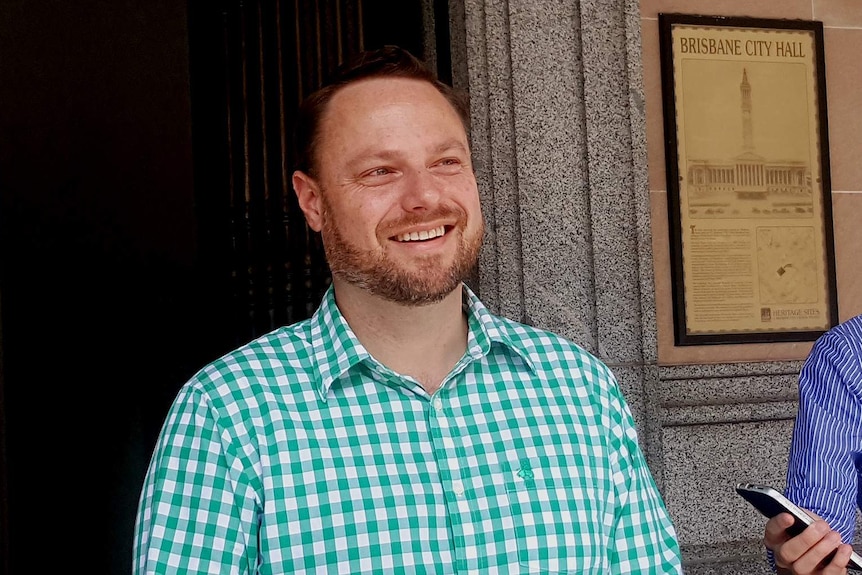 Adrian Schrinner grins during a media conference