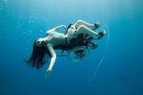 Sue Austin in a wheelchair, underwater