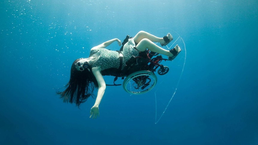 Sue Austin in a wheelchair, underwater