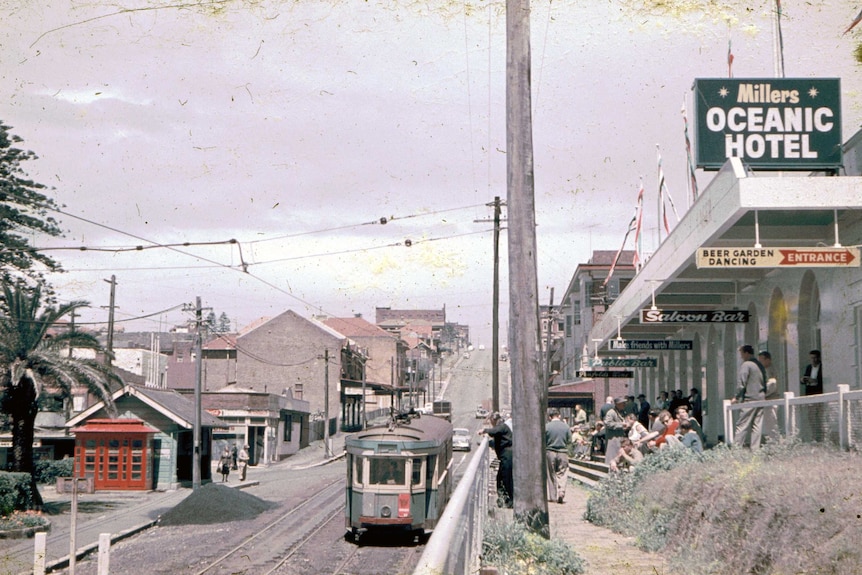 A tram passes by Millers Oceanic Hotel near Coogee Beach