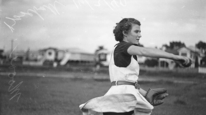 Female baseball player in action on the field in Brisbane, 1940