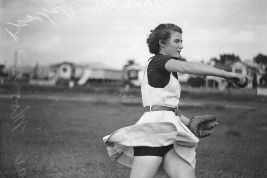 Female baseball player in action on the field in Brisbane, 1940
