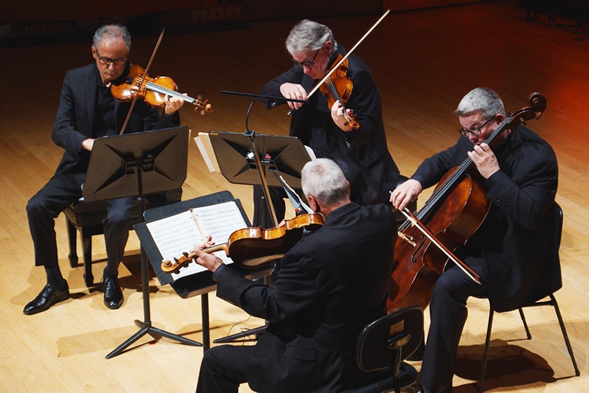 The Emerson String Quartet performing on stage, shot from above.