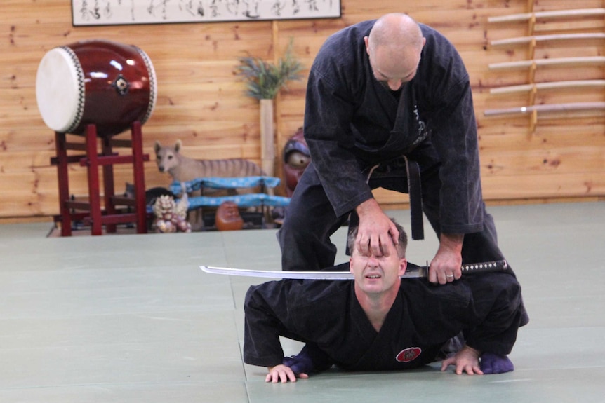 Ninja teacher Duncan Stewart demonstrates how to immobilise a person by holding a student by the eye sockets