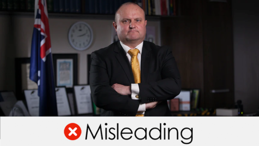 Jason Wood standing in front of a desk with arms folded. VERDICT: "Misleading" with a red cross.