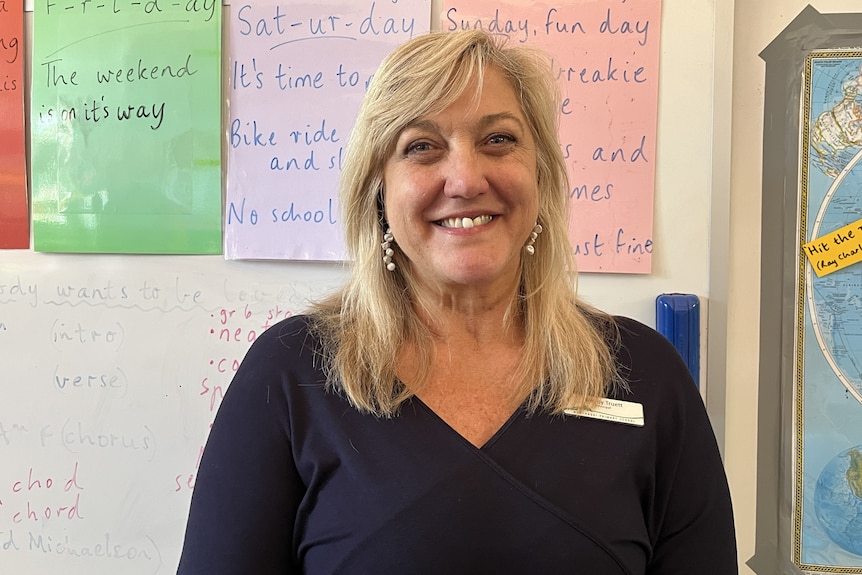 a woman with blonde hair smiles.