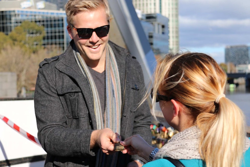 Craig Ploog and his fiancee Emily Thompson salvage their padlock from Southgate footbridge.