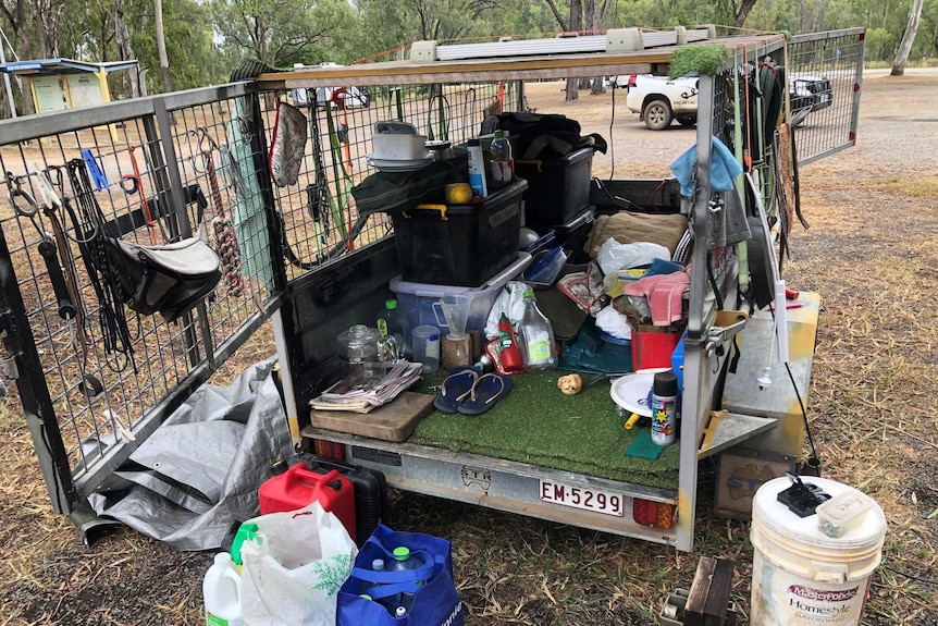 Photo of a camper trailer with camping equipment inside