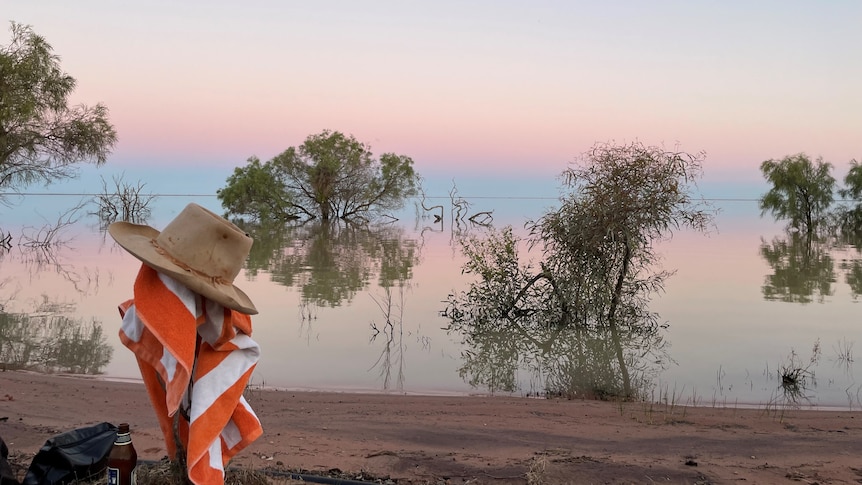 The Menindee Lakes at sunset with a hat in the foreground.