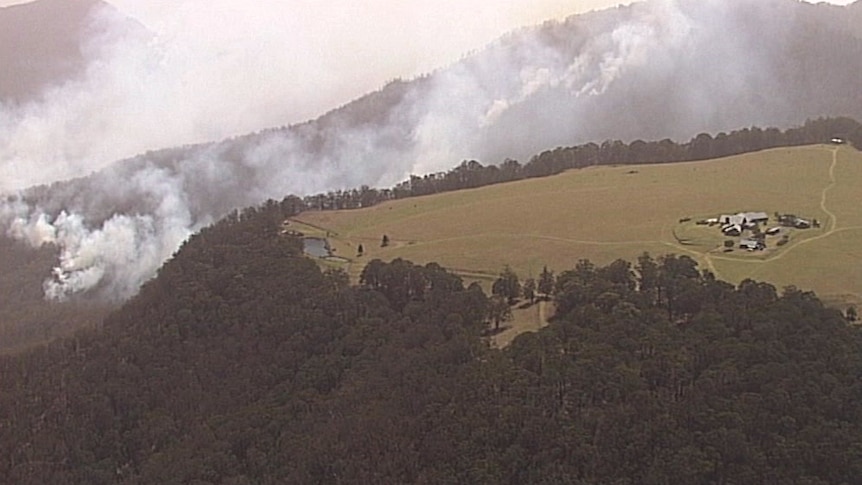 Smoke in the hills surrounding the Spicers Peak Lodge resort, a cluster of buildings on a clearing at the top of a mountain.