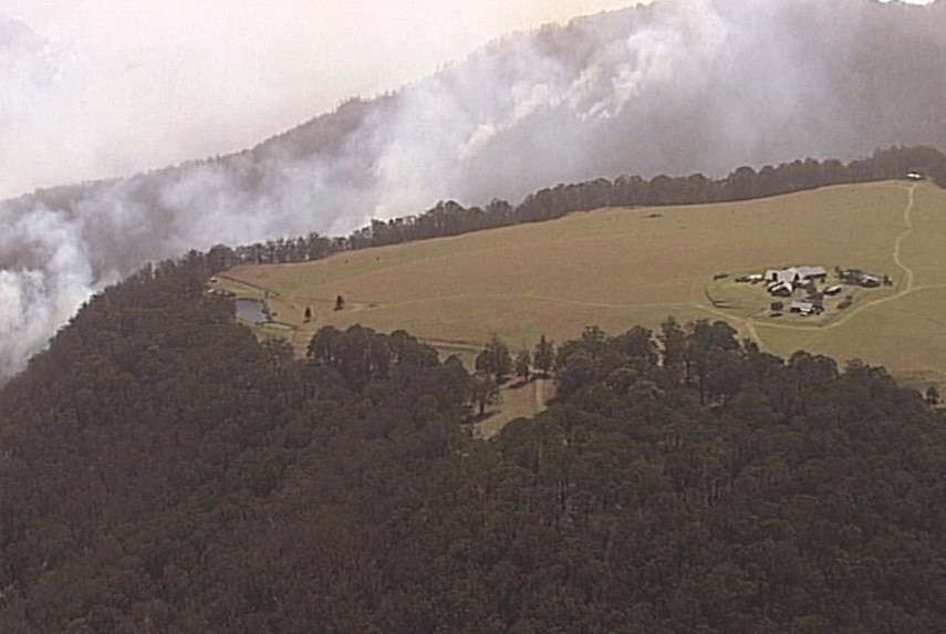 Smoke in the hills surrounding the Spicers Peak Lodge resort, a cluster of buildings on a clearing at the top of a mountain.