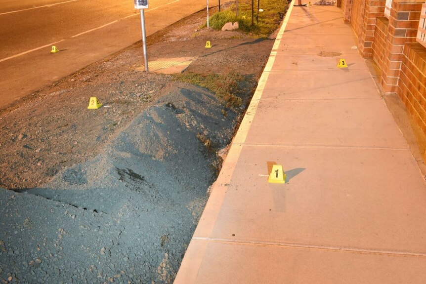 A crime scene marked out with pegs. 