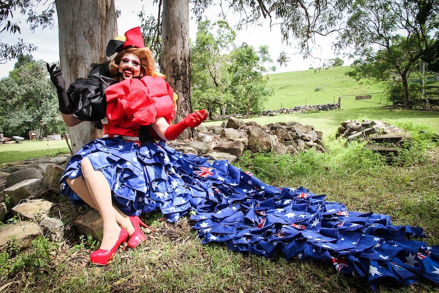 Drag queen Vin Tage' from Melbourne, reclines in the Mount Kembla countryside wearing a frock depicting the Australian flag.