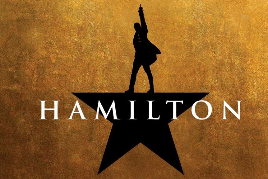 An image of a man in black with his hand in the air above a graphic of the word hamilton.