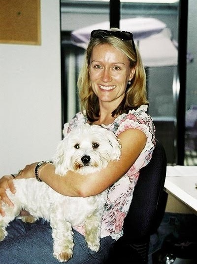 Max sits on Kasey's lap in her office showing the happy memories you will carry with you after putting down a pet dog.