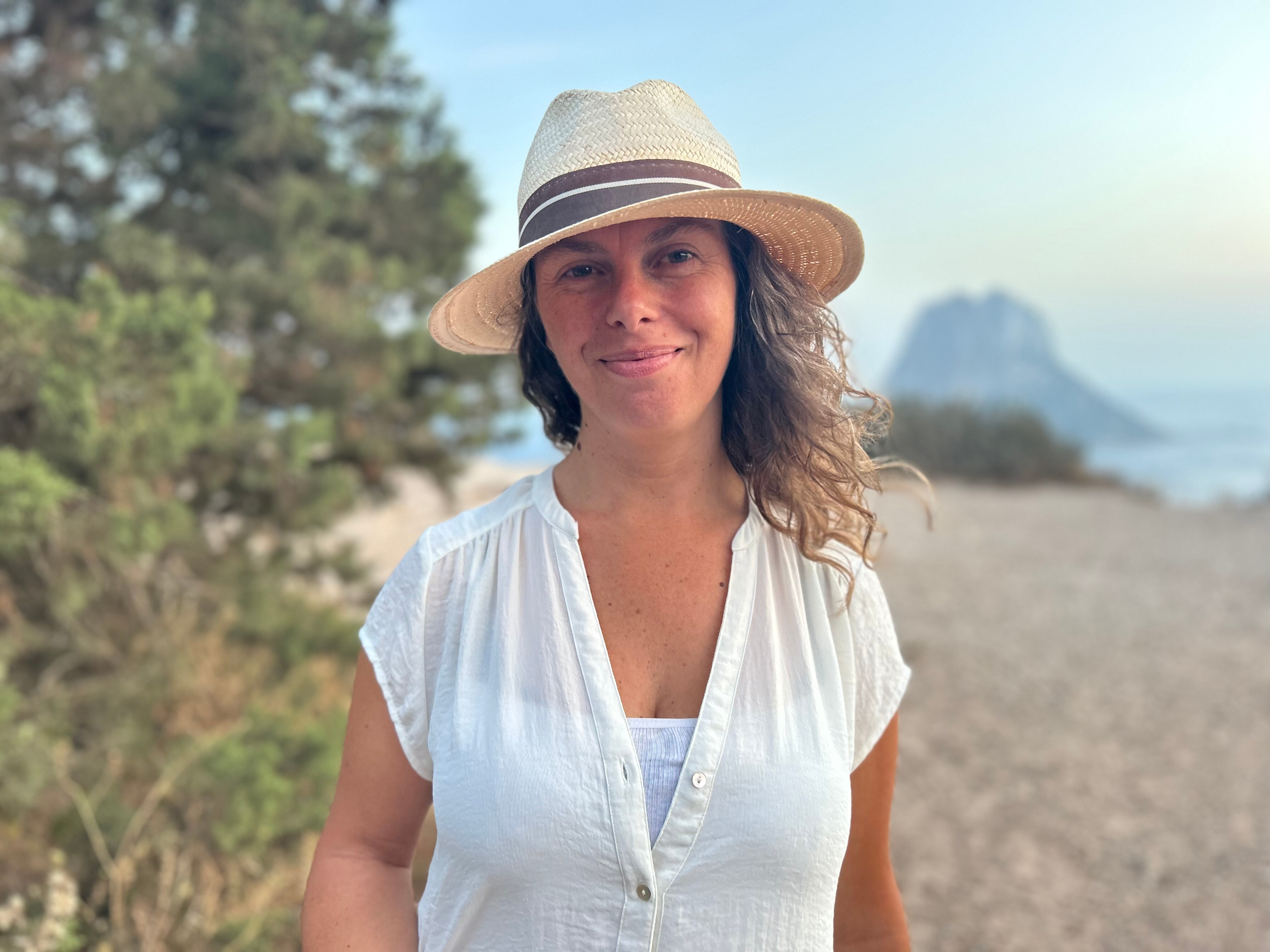 A woman leaning on a fence.