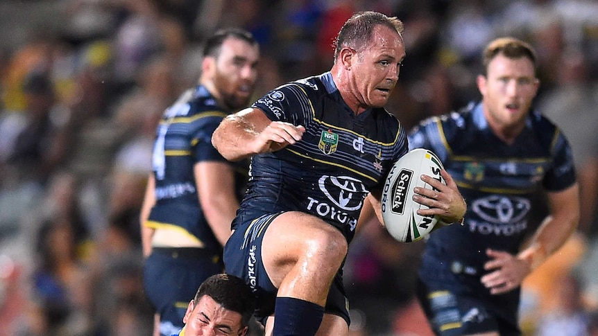 Matthew Scott of the Cowboys is tackled by Nathan Peats of the Eels