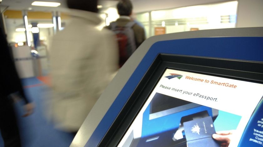 Passengers walk past a SmartGate at Sydney International Airport