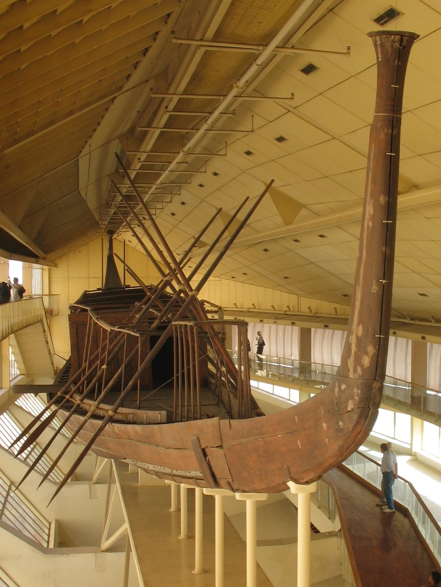 A wooden boat on display in a museum.