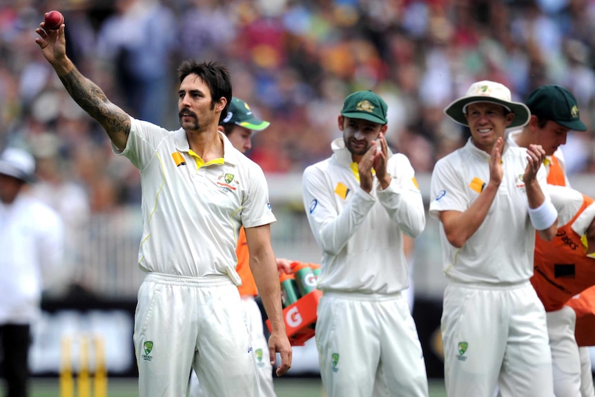 Mitchell Johnson holds the ball aloft after claiming his fifth wicket for the innings.