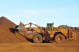 A digger moving iron ore at a Fortescue mine in the Pilbara