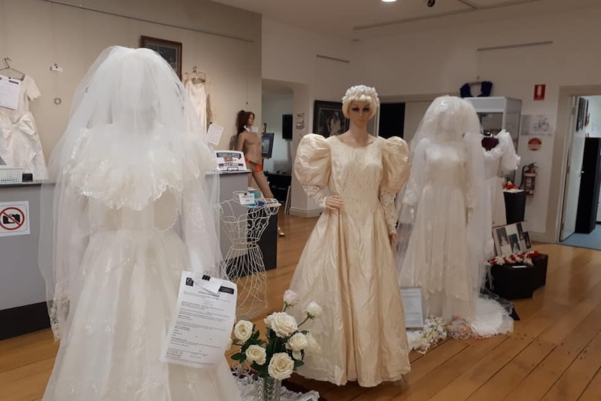 Wedding dresses in an art gallery.