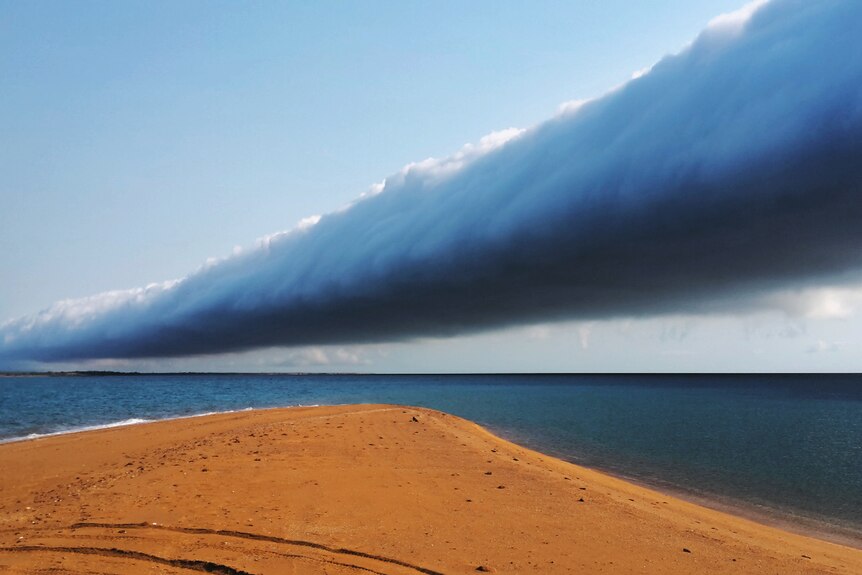 an unusual cloud over a tropical beach