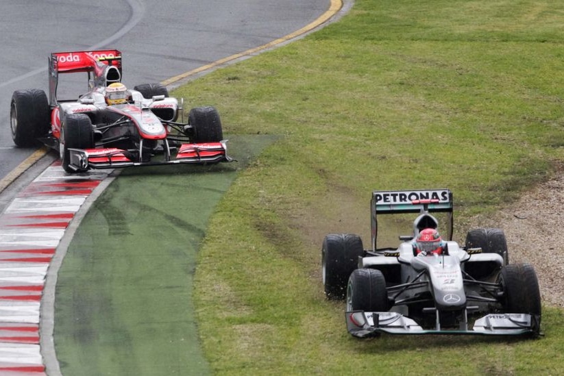 Michael Schumacher leads Lewis Hamilton off the track during the Australian F1 Grand Prix