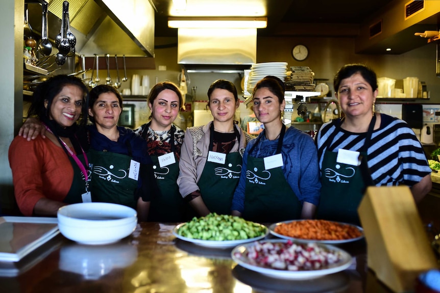 Women standing together in kitchen