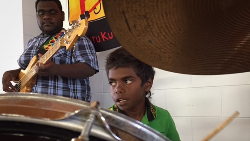 Aboriginal boy plays drums