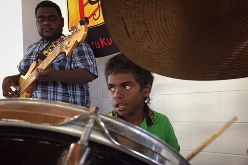 Aboriginal boy plays drums
