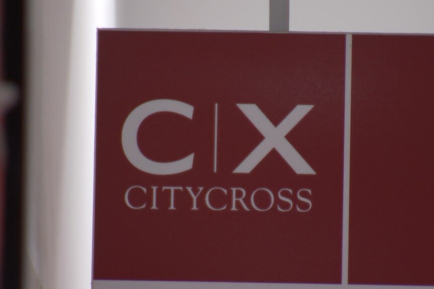 A red sign reading 'C X City Cross'