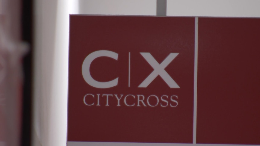 A red sign reading 'C X City Cross'