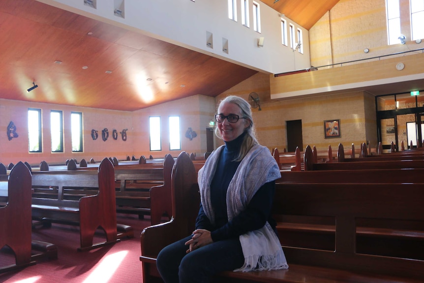Ruth Barker sits in a pew at an empty St Anthony's Church in Perth.