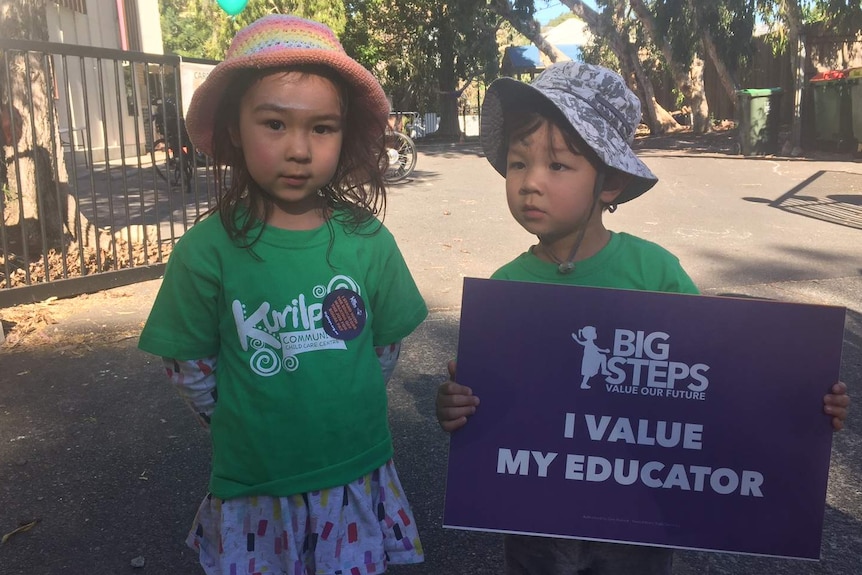 Children join a protest over childcare worker wages in Brisbane