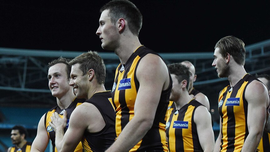 Hawthorn players walk off the Olympic stadium after beating the Sydney Swans on July 18, 2014.