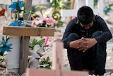 A relative of murdered teen sisters cries in the cemetery in Ciudad Juarez.