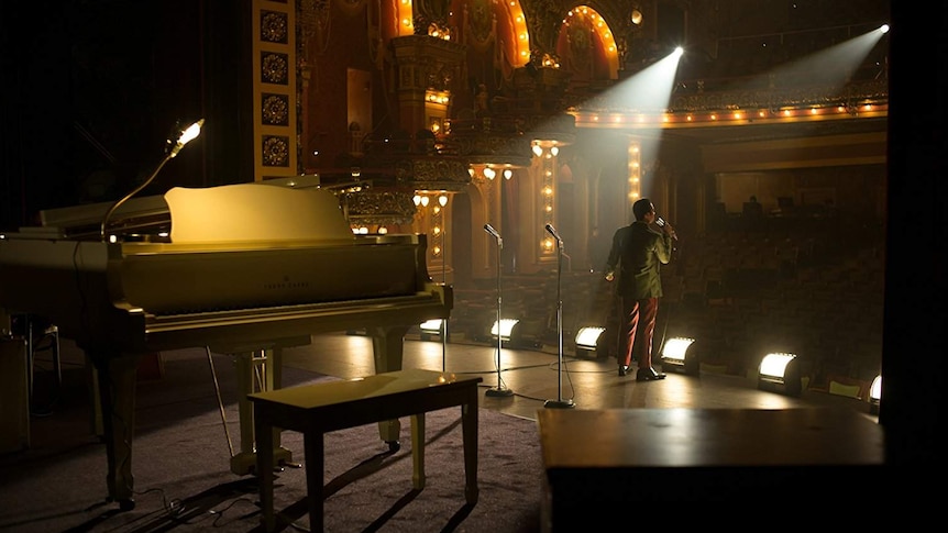 Colour photograph of actor Algee Smith performing a musical number inside Fox Theatre in 2017 film Detroit.