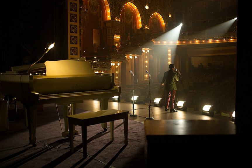 Colour photograph of actor Algee Smith performing a musical number inside Fox Theatre in 2017 film Detroit.