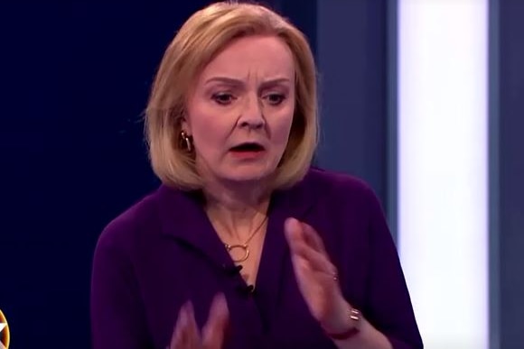 Liz Truss wears a shocked expression.