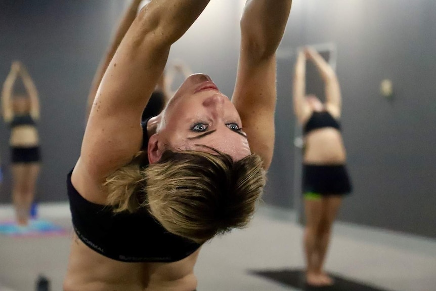 A woman makes a yoga pose.